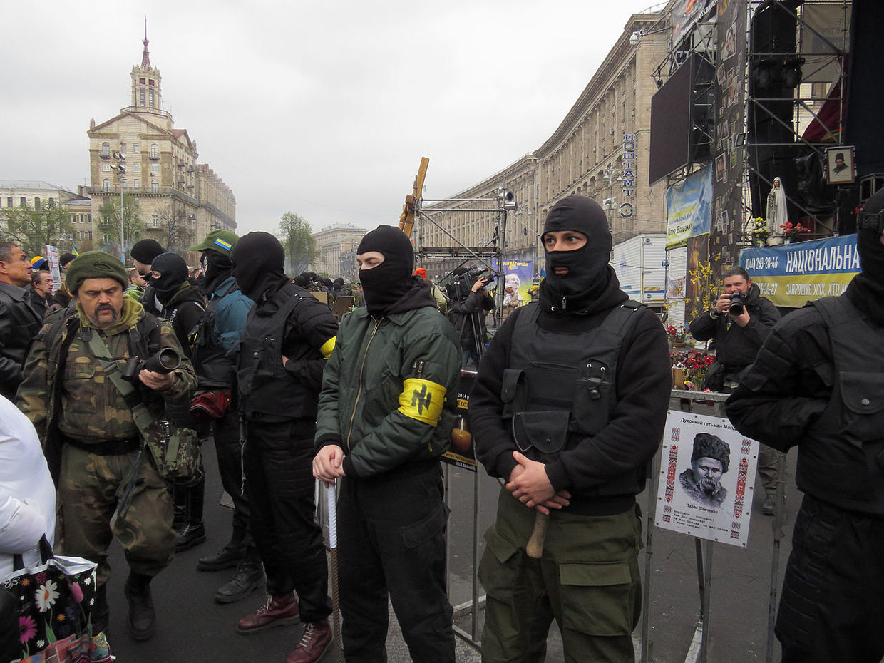 Members of the 'Patriot of Ukraine' stand guard at the event of the 'Right Sector'