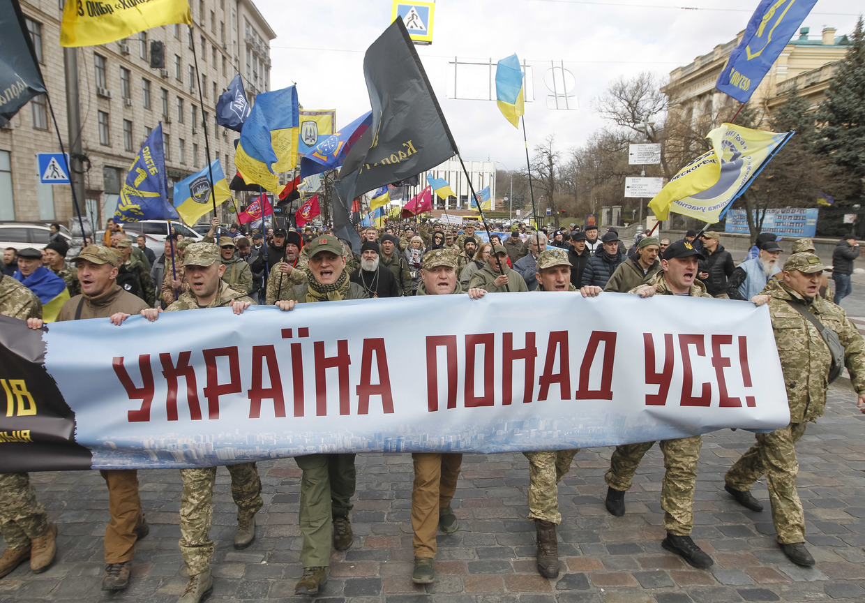 'Azov' far-right activists carrying a 'Ukraine above all' banner at a march